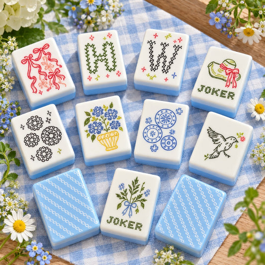 Sky blue floral mahjong tiles on a table, the real pieces behind the mahjong board game label